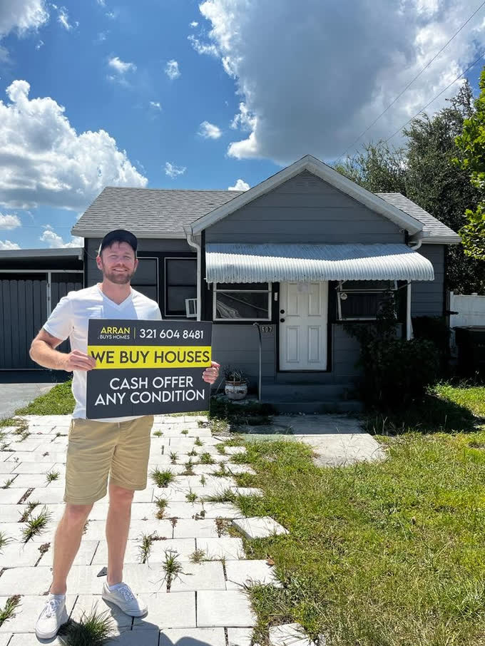 Arran in front of a house purchased as-is in Central Florida